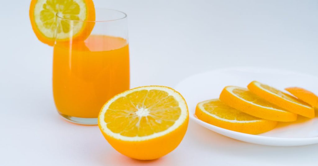 Vibrant orange juice with lemon and orange slices, perfect for a healthy lifestyle.